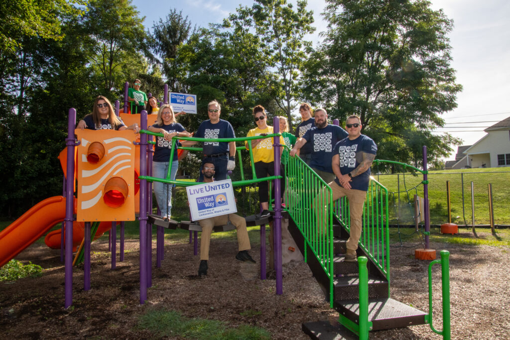Day of Caring volunteers working together at a playground.