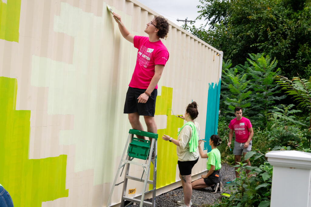 Day of Caring volunteers painting.